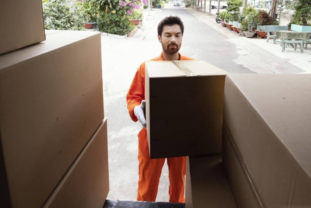 An office removals crew at the back of the truck placing a box in the concept of 'What Are Office Removals Services'.