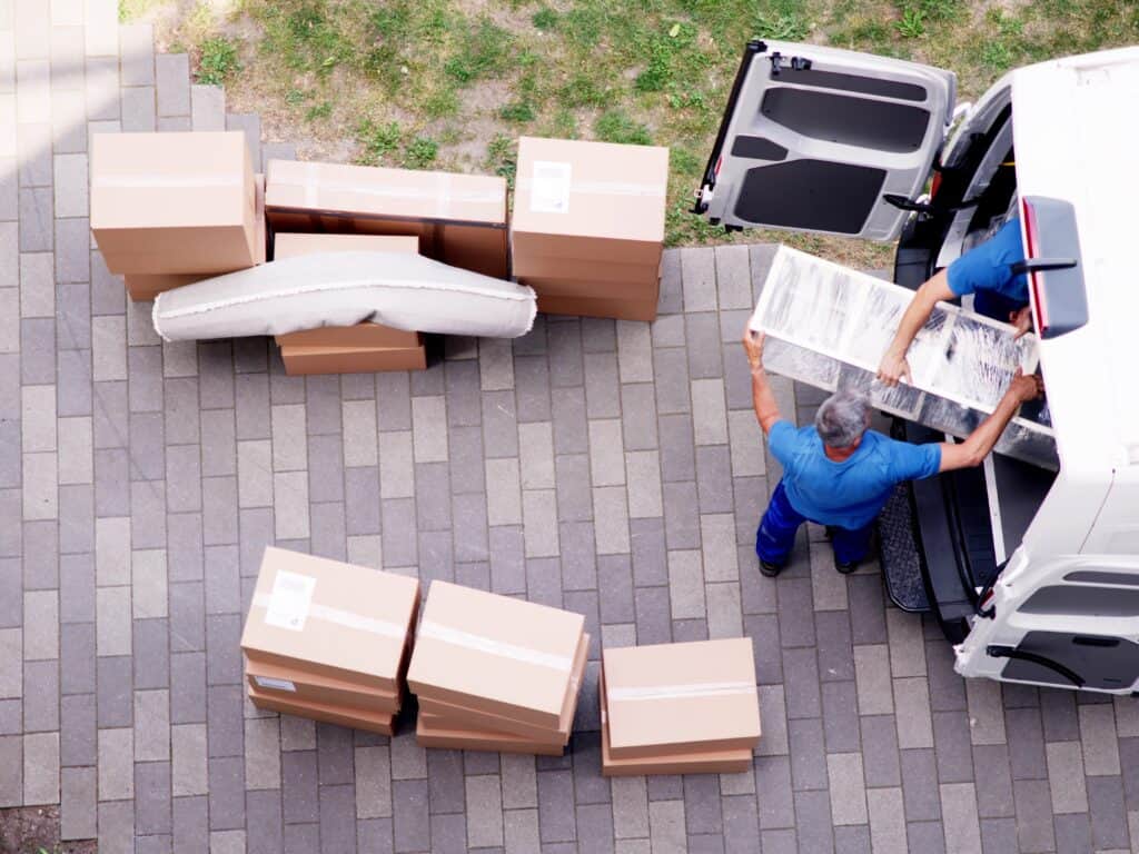 Top view of man and van placing items inside the van
